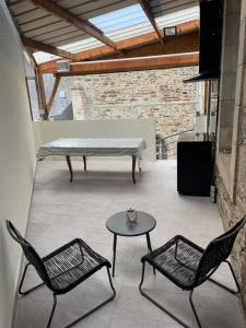 a patio with two chairs and a table and a bench at Maison de ville in Lannion +1 photo