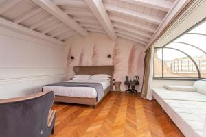 a bedroom with a bed and a large window at Hotel The Corner Roma in Rome