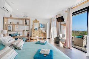 a bedroom with a blue bed and a living room at Villa Louancelie B&B in Cavalaire-sur-Mer