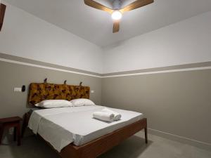 a bedroom with a bed with a ceiling fan at Extraordinary sea view in Sal Rei