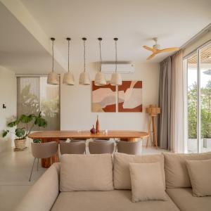 a living room with a couch and a table at Villa Vista, 5BR Beach Front SeaView Haven, Steps to Sand in Haad Pleayleam