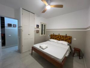 a bedroom with a bed with a ceiling fan at Extraordinary sea view in Sal Rei +36 photos