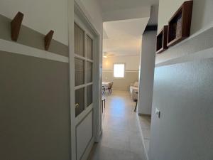 a hallway with a white door and a dining room at Extraordinary sea view in Sal Rei