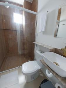 a bathroom with a shower and a toilet and a sink at Pousada Serra do Torreão in João Câmara +33 photos