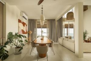 a living room with a table and a couch at Villa Vista, 5BR Beach Front SeaView Haven, Steps to Sand in Haad Pleayleam
