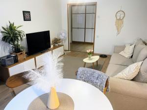 a living room with a couch and a table at Vabaduse apartment in Võru