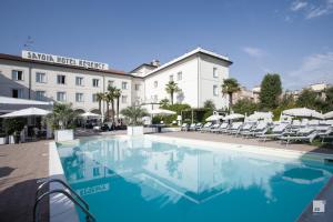 a hotel with a swimming pool in front of a building at Savoia Hotel Regency in Bologna