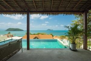 a view of the ocean from the balcony of a villa at Villa Vista, 5BR Beach Front SeaView Haven, Steps to Sand in Haad Pleayleam