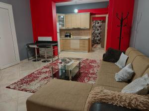 a living room with a couch and a kitchen at Magda's apartments in Perea