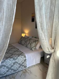 a bedroom with a bed and curtains in a room at Sunny Beachfront Apartment in Nerántza