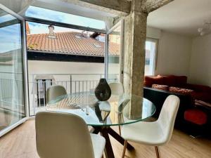 a dining room with a glass table and chairs at MUNDAKA Centre 2 in Mundaka
