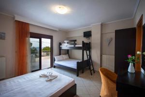 a room with a bed and a desk with a table at Villa Amalia Sun Beach in Nea Vrasna +195 photos