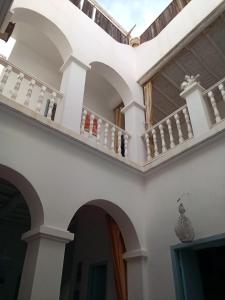 a building with arches and balconies on it at RIAD Adam in Sidi Ifni