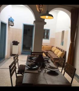 a living room with a table and a couch at RIAD Adam in Sidi Ifni