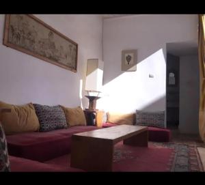 a living room with a couch and a coffee table at RIAD Adam in Sidi Ifni
