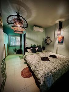 a bedroom with a large bed and a chandelier at MILD ISLAND STAY ROOm in Phi Phi Islands