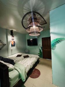 a bedroom with a bed and a large chandelier at MILD ISLAND STAY ROOm in Phi Phi Islands