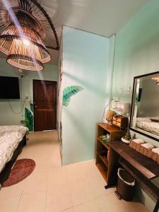 a bedroom with a mirror and a bed and a table at MILD ISLAND STAY ROOm in Phi Phi Islands