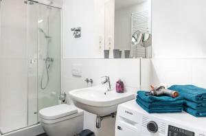 a white bathroom with a sink and a toilet at Elb Park Suite in Wittenberge