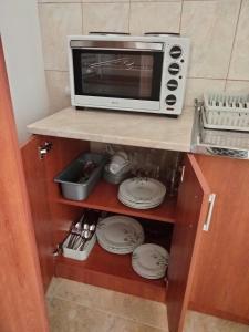 a microwave oven sitting on top of a kitchen counter at Hillside Haven in Sutorina