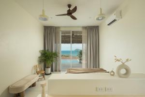 a bedroom with a bed and a ceiling fan at Villa Vista, 5BR Beach Front SeaView Haven, Steps to Sand in Haad Pleayleam +33 photos