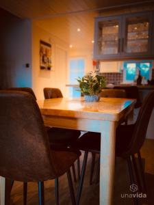 a wooden table with chairs and a plant on it at Barneys Retreat - Lakeside Getaway in South Cerney