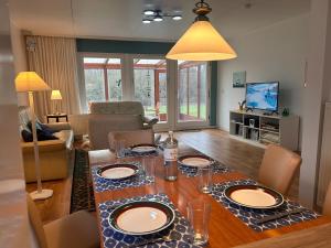 a living room with a table with plates on it at Küstenhuus in Utersum