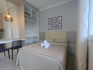 a bedroom with a bed with two pillows on it at Studio 02# Aconchego e tranquilidade em Floripa Muito Top e tranquilo in Florianópolis