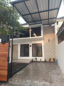 a house with a metal roof over a garage at Adah 786 Villa Syariah in Krian +4 photos