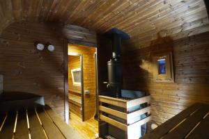 a room with a stove in a wooden wall at General House in Namsskogan +23 photos