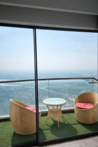 a room with two chairs and a table and a window at Yamunaviewnest in Noida