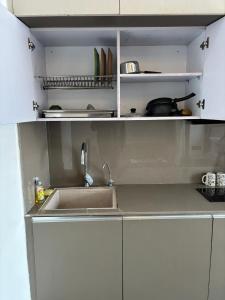 a kitchen with a sink and a counter top at Yamunaviewnest in Noida