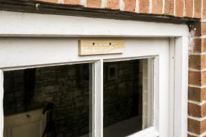 a sign on the door of a window at The Grain store in Cirencester