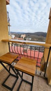 a balcony with two benches and a view of a city at Perspective View in Veliko Tŭrnovo +12 photos