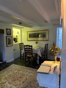 a dining room with a table and a kitchen at Trewetha Cottage Bed & Breakfast in Port Isaac