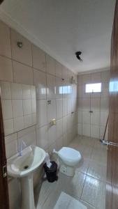 a bathroom with a sink and a toilet at Hotel Universo in Goiânia +16 photos