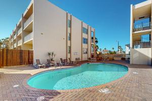 a swimming pool in front of a building at Fiesta Sol Condominiums #109 in South Padre Island