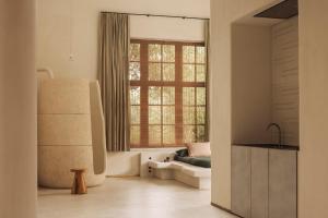 a living room with a large window and a couch at Jonojé Luxury Suites in Bruges