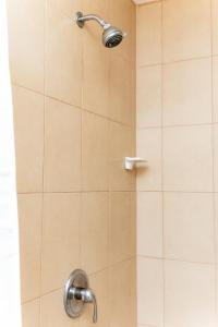a shower with a shower head in a bathroom at St Kitts Castle Suites in Basseterre +15 photos