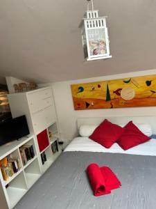 a bedroom with a bed with red pillows on it at A Modo Mio - Monolocale - Zona Stadio Ospedale Maggiore in Bologna