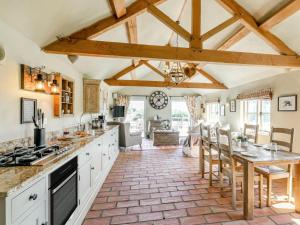 a kitchen with white cabinets and a table with chairs at 2 Bed in York oc-g0073 in Ellerton