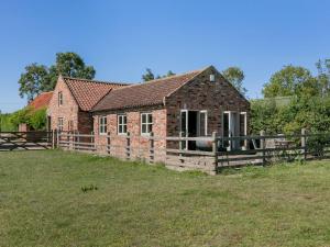 an old brick house with a fence in a field at 2 Bed in York oc-g0073 in Ellerton