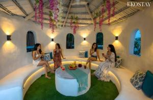 a group of women sitting on couches in a room at Ekostay Luxe - CASA SIA - Ideal for Big Groups- Poker Table in Lonavala
