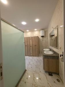 a bathroom with two sinks and a mirror at Swisstay Downtown Cairo in Cairo +86 photos