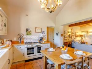 a kitchen with a wooden table and a dining room at 2 Bed in York oc-g0154 in Ellerton