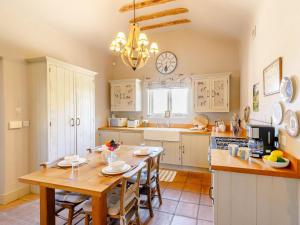 a large kitchen with a wooden table and chairs at 2 Bed in York oc-g0154 in Ellerton +6 photos