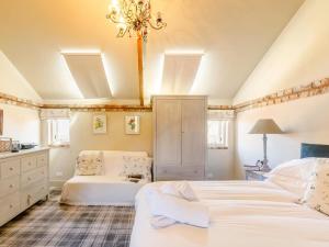 a bedroom with two beds and a chandelier at 2 Bed in York oc-g0154 in Ellerton
