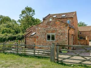 an old brick building with a wooden fence at 2 Bed in York oc-g0154 in Ellerton