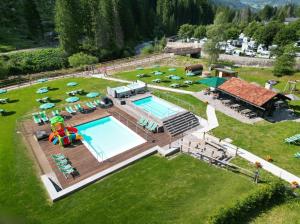 an aerial view of a resort with a swimming pool at Hotel Grohmann in Campitello di Fassa