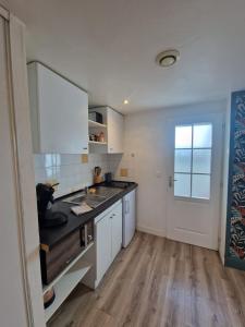 a kitchen with a sink and a counter top at Cozy studio Libourne Train station within walking distance in Libourne +30 photos